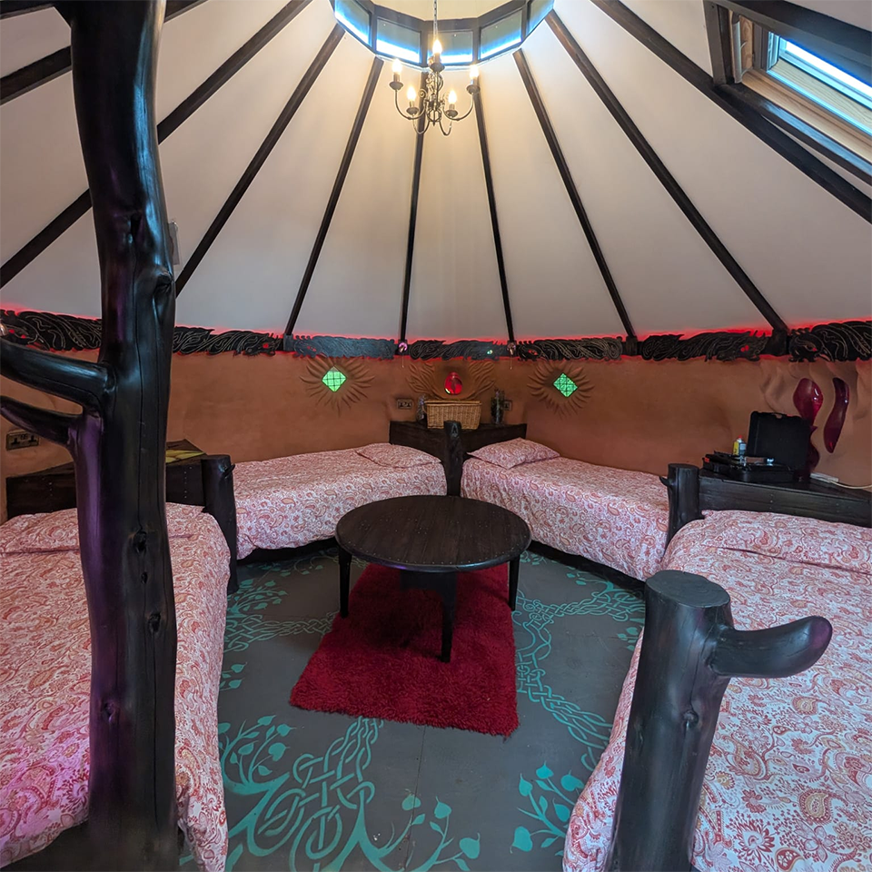 4 Single beds inside Fire Cob Glamping Pod